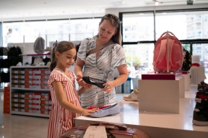 Back To School Shopping Concept. Mother and her two children are shopping for school.